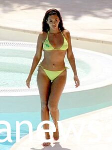 Annie Murphy in a yellow bikini