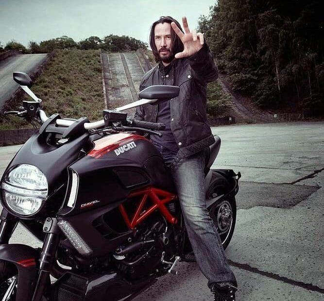 Keanu Reeves: on a big bike ,black
