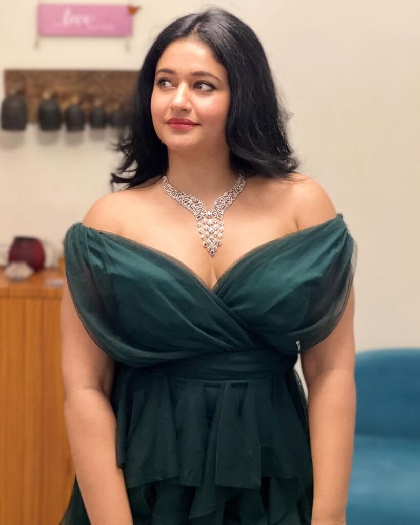 Poonam Bajwa:in a green dress