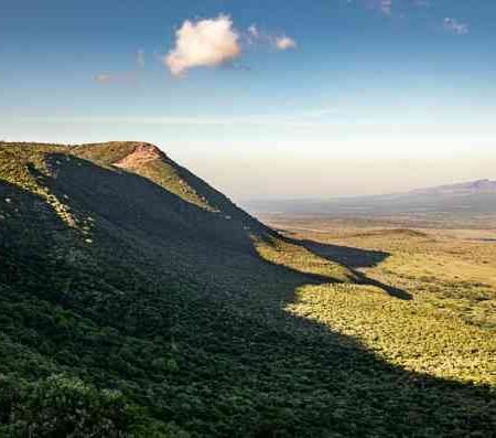 Panoramic view of Rift Valley escarpment Kenya:escarpments under shadow from casting sun
