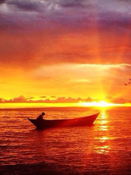 Vibrant Sunset Colors Over Lake Victoria Fishing Boats: